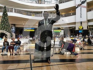 People waiting in arivals terminal at O R Tambo international airport with Oliver Tambo