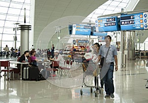 People in the waiting lounge of Dubai Airport terminal