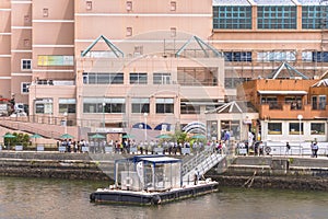 People waiting in row at the pontoon of the cruise of Yokosuka Naval Port in the Yokosuka naval Base.