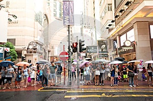 People waiting to cross through busy streets at Hong Kong Times
