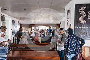 People waiting to disembark Delos Tours boat that has just arrived to to the island of Delos, Greece