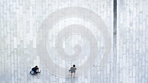 People walk on across business city street Aerial top view