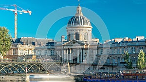 People walk on the Bridge of Arts over the River Seine between the Institute of France and the Louvre timelapse - Paris