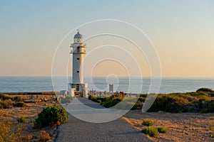 People walk down the street towards the Cap de Barbarie Lighthouse in Formentera in the summer of 2021