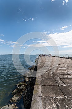 People walk on hte great south walk at Pollbeg lighthouse.