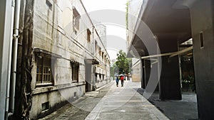 people walk on the pedestrian walk wak with the old stle building in the city