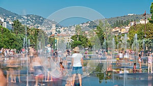 People walk on a Promenade du Paillon park timelapse, famous with its flat fountains in Nice, France. photo