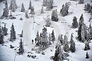 People walk in snowy winter mountains country, Krkonose, freezing weather