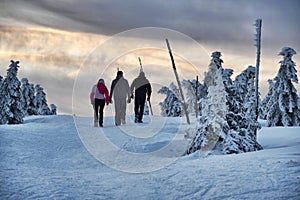 People walk in snowy winter mountains country, Krkonose, freezing weather