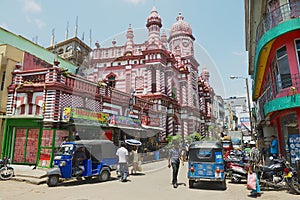 People walk by the street with colonial architecture building at the background in downtown Colombo, Sri Lanka.