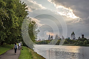 People walk in the summer warm evening in the park