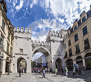 People walking along through the Karlstor gate in Munich