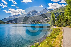 People walking along Lake Sankt Moritz in Swiss Alps photo