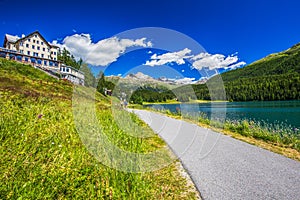 People walking along Sankt Moritz lake