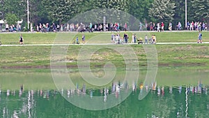 People walking along the shore of Lake Jarun