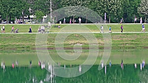 People walking along the shore of Lake Jarun in Zagreb