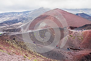 People walking aroud the crater of Etna volcano, Sicily, Italy