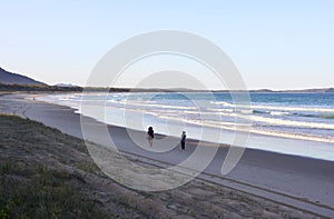 People walking on the beach at Crowdy National Park, NSW, Australia photo