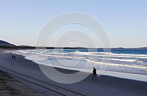 People walking on the beach at Crowdy National Park, NSW, Australia photo