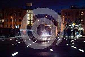 People walking in the city street in the evening.