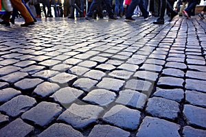 People walking cobblestones