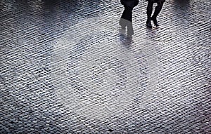 People walking on a cobblestones path
