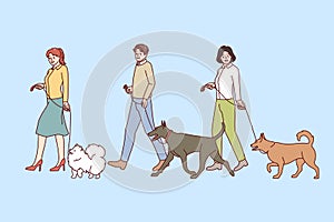 People walking with dogs on leashes