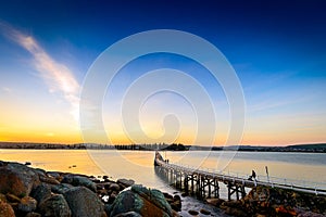 People walking down the foot bridge at sunset, Victor Harbor, SA