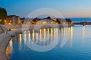 People walking embankment Arles, France photo