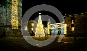 People walking and enjoying the Christmas lights in the medieval old town of Puebla de Sanabria. Zamora. Spain.