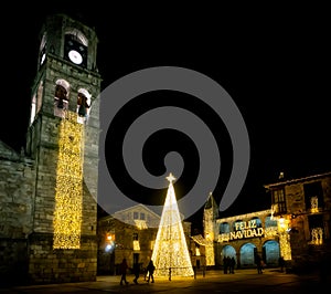 People walking and enjoying the Christmas lights in the medieval old town of Puebla de Sanabria. Zamora. Spain.