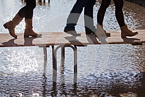 People walking at flood on a footbridge