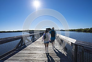 People walking in the Florida park by the lake.