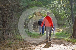 People Walking Through a Forest