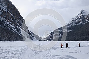 people walking on the frozen Lake Louise in winter