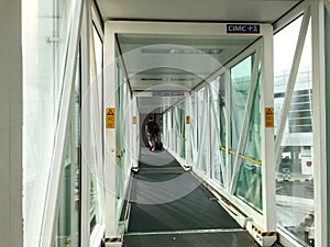 People walking in the gangway at the airport in Bali, Indonesia