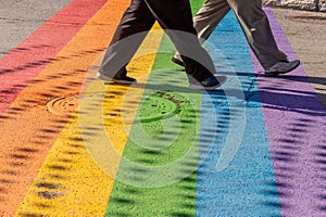 People walking on gay rainbow crosswalk in Montreal gay village