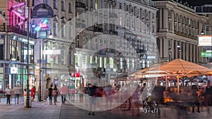 People is walking in Graben St. night timelapse, old town main street of Vienna, Austria. photo