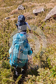 People walking with great backpacks in mountain landscape - trekking hiking mountaneering in mantiqueira range Brazil