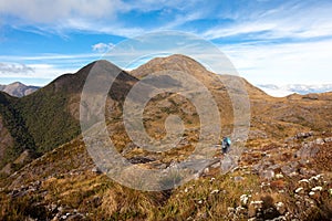 People walking with great backpacks in mountain landscape - trekking hiking mountaneering in mantiqueira range Brazil