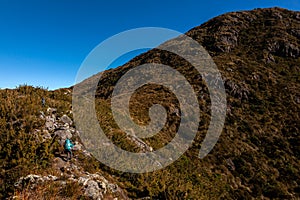 People walking with great backpacks in mountain landscape - trekking hiking mountaneering in mantiqueira range Brazil