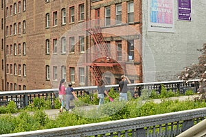 People Walking on the Highline and Viewing the Manhattan West Side Cityscape NYC