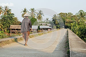 People walking on the historical bridge between Don Det and Don Khon. built by the French on the Mekong river