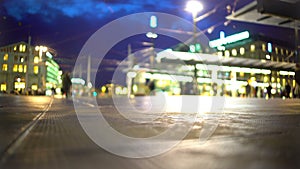 People walking in a hurry near illuminated airport building, hectic city life