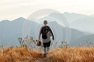 People walking in mountain landscape - trekking hiking mountaneering