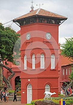 People are walking nearly the Clock tower in Malacca