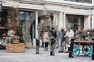 People walking past Petersham Nurseries in Covent Garden, London, UK.