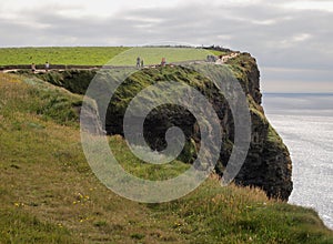 People walking on path along the Cliffs of Mohr