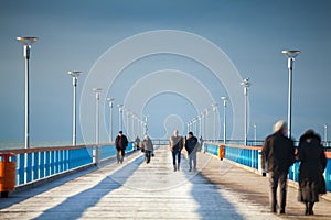 People walking on the pier photo