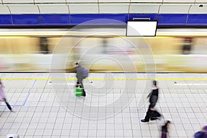 People walking on platform at metro station